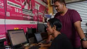Two men look at a computer