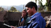 An MFI agent works with a customer, using a tablet