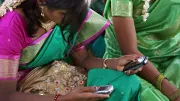 A woman uses a cell phone in a meeting
