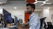 A young man works at a computer