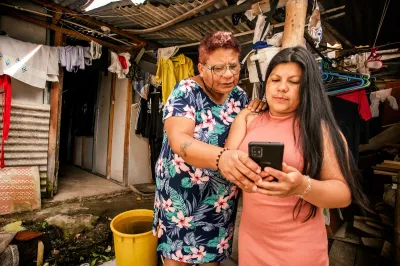 Two women look at a smartphone
