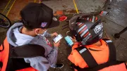 Two men look at smartphone screens
