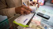A man records a money transfer