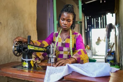 A young woman at a sewing machine