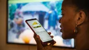 A woman speaks into her smartphone