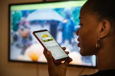 A woman speaks into her smartphone