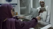 Two women exchange money