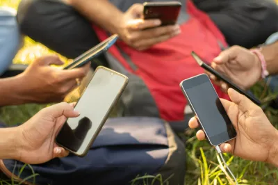 a group of people in a circle hold smart phones