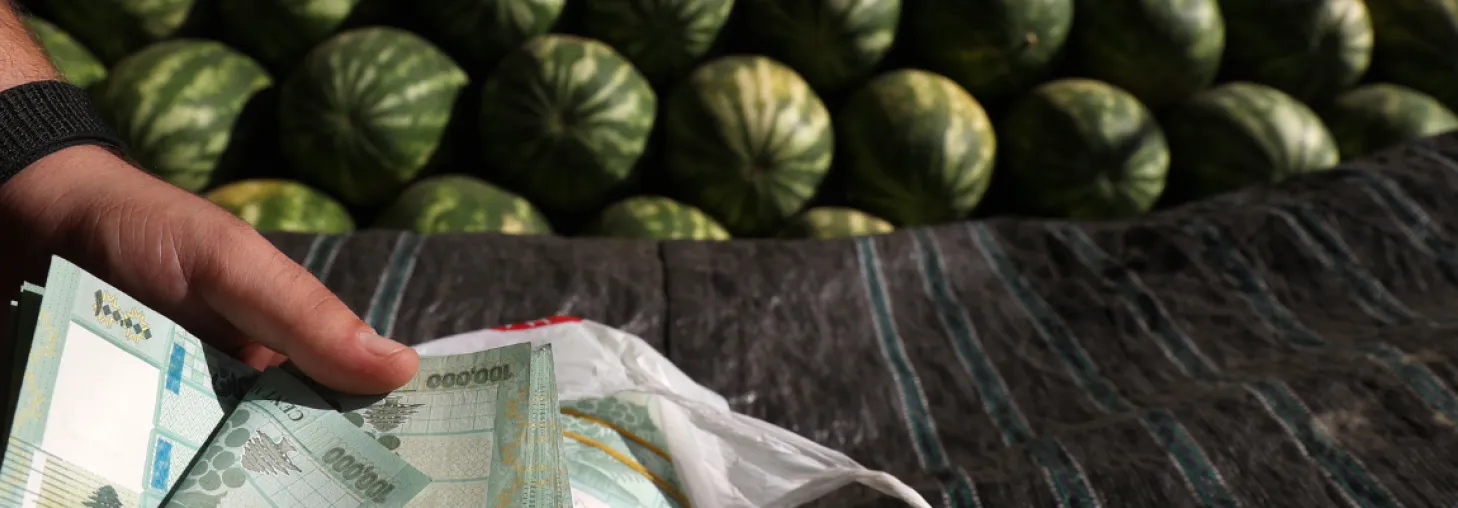 a watermelon vendor counting cash 