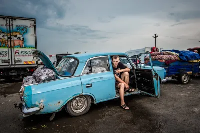 A young man sell vegetables out of his car in Ukraine