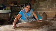 A woman rolls out dough in Mexico
