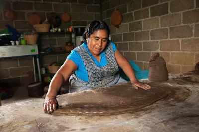 A woman rolls out dough in Mexico