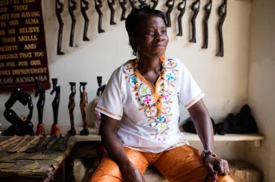 A Ghanian woman sits in her handicraft shop